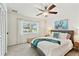 Charming bedroom features a ceiling fan, large window and stylish decor at 1286 Stony Brook Ln, Dunedin, FL 34698