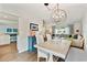 Open dining room with stylish light fixture, wood floors, and comfortable seating at 1286 Stony Brook Ln, Dunedin, FL 34698