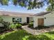 A charming single-Gathering home with manicured lawn and a brick walkway at 1286 Stony Brook Ln, Dunedin, FL 34698