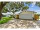 A single-Gathering home with a two car garage, brick pavers, and an American flag displayed at 1286 Stony Brook Ln, Dunedin, FL 34698