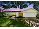 Charming single Gathering home with manicured lawn and a two car garage with a brick walkway at 1286 Stony Brook Ln, Dunedin, FL 34698