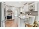 Modern kitchen features stainless steel appliances, wine rack, and quartz countertops at 1286 Stony Brook Ln, Dunedin, FL 34698
