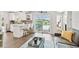 Open floorplan showcasing living area, kitchen with breakfast bar, and backyard access at 1286 Stony Brook Ln, Dunedin, FL 34698