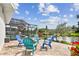 An outdoor patio space with furniture overlooking a pond in a fenced backyard at 1286 Stony Brook Ln, Dunedin, FL 34698