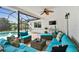 Comfortable outdoor living space with wicker furniture, ceiling fan, and pool view at 1286 Stony Brook Ln, Dunedin, FL 34698