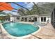 Sparkling pool and spa with a screened-in lanai for outdoor living and entertaining at 1286 Stony Brook Ln, Dunedin, FL 34698