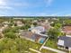 An elevated view highlighting a screened-in pool, landscaped yard, and lush trees in a peaceful residential neighborhood at 1328 Rushgrove Cir, Dover, FL 33527