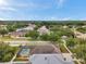 Spacious backyard with a screened-in pool, complemented by lush landscaping and mature trees in a Gathering-friendly neighborhood at 1328 Rushgrove Cir, Dover, FL 33527