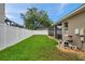 Well-maintained backyard with green lawn and white vinyl fence at 1328 Rushgrove Cir, Dover, FL 33527