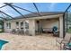 Exterior view of the home showcasing the screened patio, in-ground pool, and ample outdoor seating at 1328 Rushgrove Cir, Dover, FL 33527