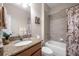 The bathroom features a granite countertop, a shower-tub combo, and neutral color tiles at 1328 Rushgrove Cir, Dover, FL 33527