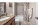 This beautiful bathroom offers granite countertops, a tiled shower-tub, and matching floral accents at 1328 Rushgrove Cir, Dover, FL 33527