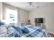 This beautiful bedroom boasts hardwood floors, a ceiling fan, and lots of natural light at 1328 Rushgrove Cir, Dover, FL 33527