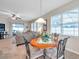 Cozy eat-in dining area next to the living room with a round wood table and lots of light at 1328 Rushgrove Cir, Dover, FL 33527