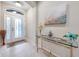Welcoming foyer with decorative front door, art display, and decorative glass table at 1328 Rushgrove Cir, Dover, FL 33527