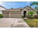 Charming single-story home with a three-car garage and well-manicured landscaping at 1328 Rushgrove Cir, Dover, FL 33527