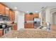 Kitchen with stainless steel appliances, granite countertops, and wood cabinetry at 1328 Rushgrove Cir, Dover, FL 33527