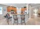 Open kitchen with a breakfast bar, stainless appliances, and tile floors at 1328 Rushgrove Cir, Dover, FL 33527