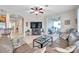 Open concept living room featuring a large TV, tile floors and access to the outdoor patio at 1328 Rushgrove Cir, Dover, FL 33527