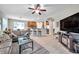 Open-concept living room features a large ceiling fan and view into the kitchen area at 1328 Rushgrove Cir, Dover, FL 33527