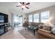 Bright and airy living room with patio access, comfortable seating, and tile flooring at 1328 Rushgrove Cir, Dover, FL 33527