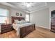 Spacious main bedroom with a tray ceiling, wood floors, and a decorative furniture set at 1328 Rushgrove Cir, Dover, FL 33527