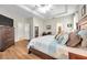 Bright main bedroom with wood floors, walk-in closet, and ensuite bathroom at 1328 Rushgrove Cir, Dover, FL 33527