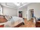 Bright main bedroom with wood floors, walk-in closet, and ensuite bathroom at 1328 Rushgrove Cir, Dover, FL 33527