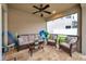 Spacious screened patio with stylish wicker furniture, ceiling fan, and access to the backyard at 1328 Rushgrove Cir, Dover, FL 33527