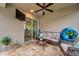 Comfortable screened patio with cushioned seating, ceiling fan, and view of interior sliding glass door at 1328 Rushgrove Cir, Dover, FL 33527