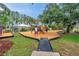 Community playground with colorful play structures and shade canopies at 1328 Rushgrove Cir, Dover, FL 33527