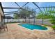 Beautiful in-ground pool with surrounding patio under a screened enclosure, offering shade and style at 1328 Rushgrove Cir, Dover, FL 33527