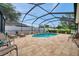 Inviting screened in-ground pool with paved deck, lounge chairs, and secure fence at 1328 Rushgrove Cir, Dover, FL 33527