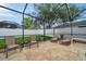 Spacious screened pool area with outdoor seating, lounge chairs, and view of the backyard at 1328 Rushgrove Cir, Dover, FL 33527