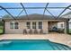 Backyard view showcasing the screened-in in-ground pool with outdoor seating, and the home's exterior at 1328 Rushgrove Cir, Dover, FL 33527