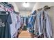 Walk-in closet features ample storage space, organized shelves, and hanging rods at 1328 Rushgrove Cir, Dover, FL 33527