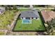 Aerial view of the fenced in yard featuring a rectangular in-ground pool and covered back patio at 14009 Wenzel Ave, Port Charlotte, FL 33981