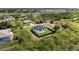 Birds eye view of property showing the pool, fenced backyard, driveway and surrounding greenery at 14009 Wenzel Ave, Port Charlotte, FL 33981