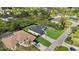 Aerial view of the property showing the modern home, black fence, driveway, and neighboring houses at 14009 Wenzel Ave, Port Charlotte, FL 33981