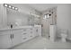 Bright bathroom with double vanity, black hardware, glass shower, and toilet at 14009 Wenzel Ave, Port Charlotte, FL 33981