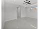 Spacious, bright bedroom with tile flooring, fan and a window at 14009 Wenzel Ave, Port Charlotte, FL 33981