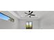 Well-lit bedroom with a ceiling fan, tray ceilings, and modern windows offering a bright and comfortable space at 14009 Wenzel Ave, Port Charlotte, FL 33981
