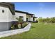 Beautiful single-story home featuring a lush lawn, garden beds, and a paved walkway leading to the front door at 14009 Wenzel Ave, Port Charlotte, FL 33981