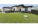 Landscaped front yard with a two-tone color scheme, featuring a well-maintained lawn and modern design at 14009 Wenzel Ave, Port Charlotte, FL 33981