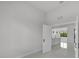 A hallway view leading to an open-concept kitchen with a breakfast bar and modern pendant lighting at 14009 Wenzel Ave, Port Charlotte, FL 33981