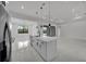 Open-concept kitchen with a large island, modern lighting, and stainless steel appliances, perfect for entertaining at 14009 Wenzel Ave, Port Charlotte, FL 33981