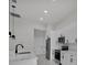 Modern kitchen equipped with stainless steel appliances, white cabinets, and stylish pendant lighting at 14009 Wenzel Ave, Port Charlotte, FL 33981