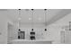 Modern kitchen with stainless steel appliances, a spacious island, and sleek pendant lighting for stylish functionality at 14009 Wenzel Ave, Port Charlotte, FL 33981