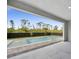 Inviting view of the backyard pool, framed by an open patio area and lush landscaping at 14009 Wenzel Ave, Port Charlotte, FL 33981