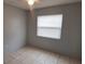 Neutral bedroom with tile floors, a window, and a ceiling fan at 1401 43Rd S St, St Petersburg, FL 33711